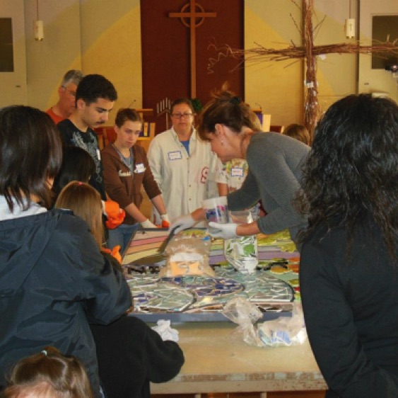 During the workshops, mosaic artist Leslie Scott taught and encouraged the volunteers in the placement of the tile